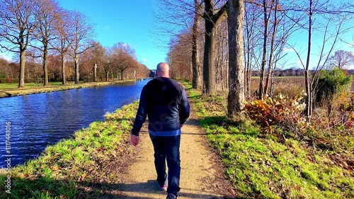 Wallpaper Mural Enjoying a peaceful stroll along a serene, tranquil canal that is beautifully surrounded by vibrant seasonal trees Torontodigital.ca