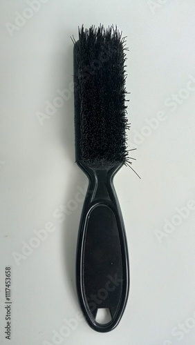 Small plastic bristle brush on white color background.
