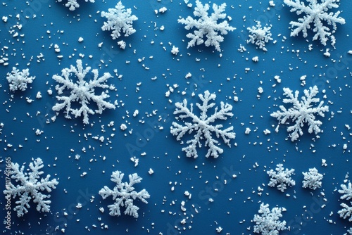 A collection of white snowflakes on a blue background, creating a winter-themed design.