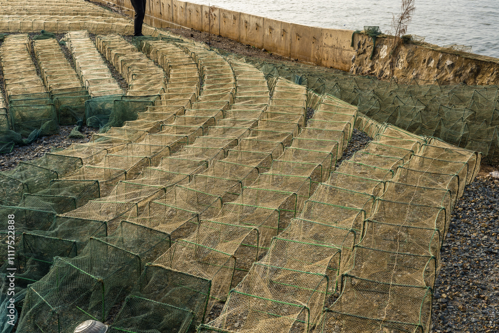 Obraz premium Fishermen's boats and crab fishing traps on the shore in Kep, Cambodia