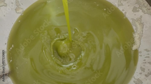 Wallpaper Mural Flow of Olive Oil Being Collected After Extraction at Olive Oil Factory Torontodigital.ca