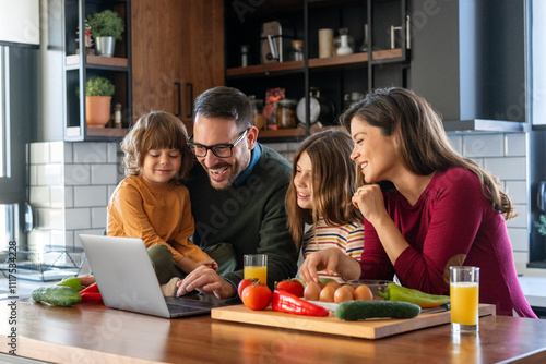 Happy parents at the kitchen counter with their children at home, enjoying weekend together photo