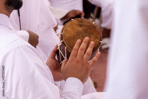 Qatari man drumming on old drums in traditional dance (Al Ardha).