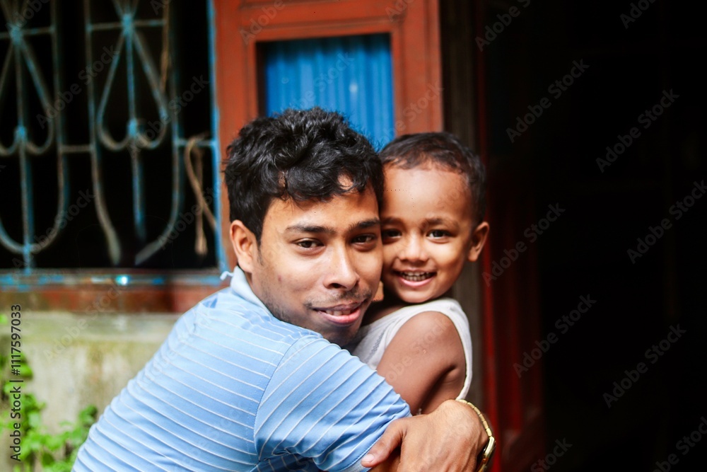 Obraz premium South asian young father hugging his son in outdoor, happy family photo, family togetherness concept 
