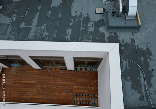 terrace on the balcony made of simple planks. roof garden custom construction. top view for arrangement and design of seating and green boxes. wood coating will help long life photo