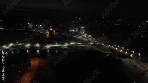 Aerial View of the Dobele City Night Landscape With Park, Livonia Order Castle Ruins in Latvia Near Berze River. Castle and Park Illuminated With Lights at Night. photo