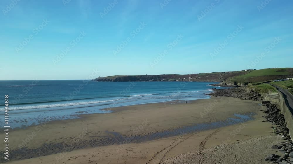 Sandy beach and rural coastal road with headland, aerial over Red Strand, West Cork Ireland Sandy beach and rural coastal road with headland, aerial over Red Strand, West Cork Ireland