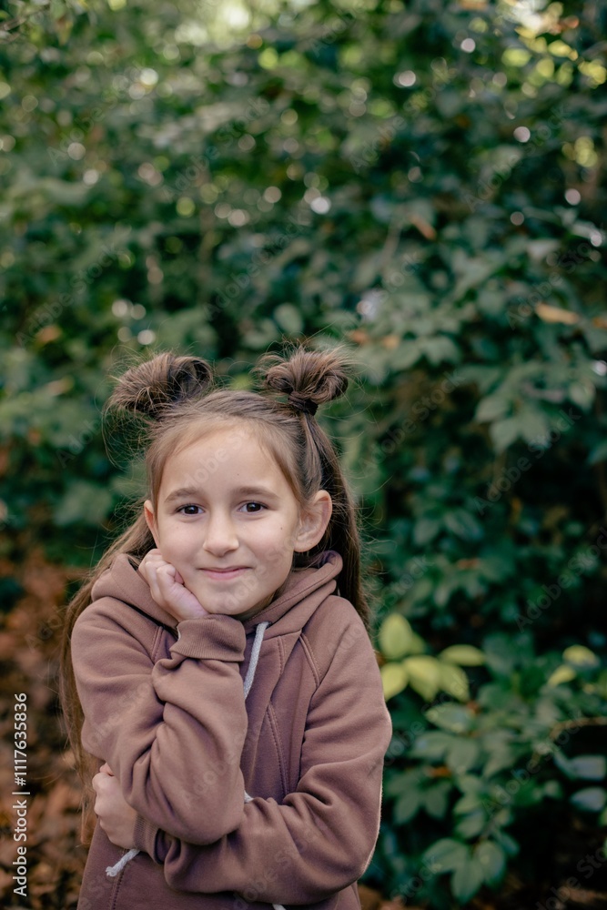 cute little girl in the autumn forest in a brown sweater cute little girl in the autumn forest in a brown sweater