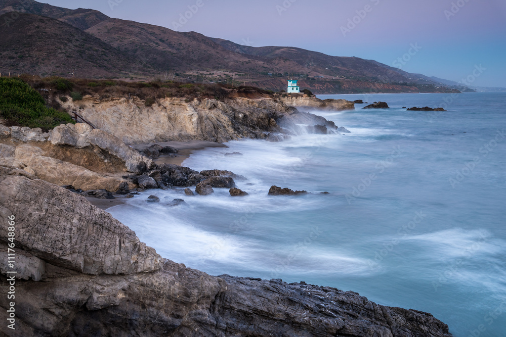 Waves crashing against rocky shore in Malibu
