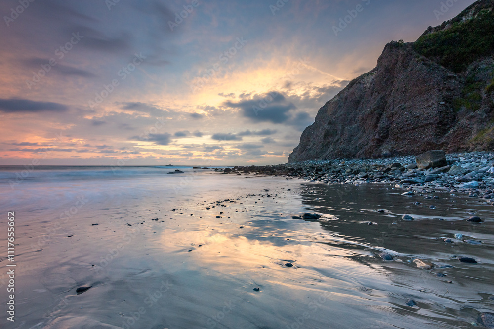Sunset reflections on Dana Point beach water