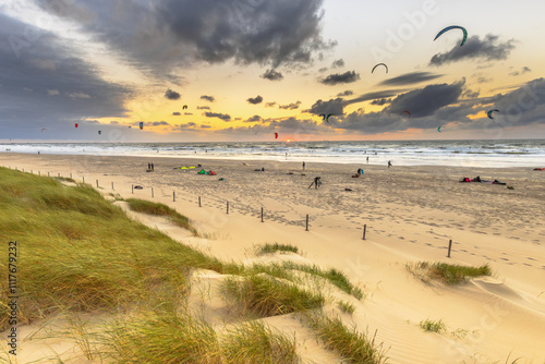 Kitesurfing seen from the dunes at sunset