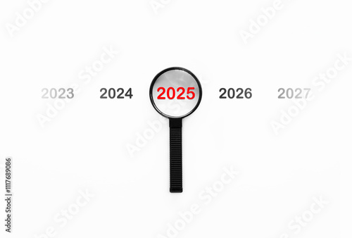Magnifying glass focusing on year 2025 in new business of happy new year and merry Christmas concept.