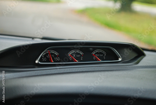 Additional gauges in a modern turbocharged performance car. Turbo boost pressure, oil temperature and oil pressure gauge on the dashboard