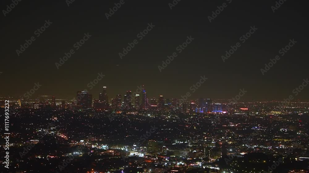 The Los Angeles skyline is illuminated at night, showcasing iconic skyscrapers and vibrant city lights against the dark sky. The Los Angeles skyline is illuminated at night, showcasing iconic skyscrapers and vibrant city lights against the dark sky.