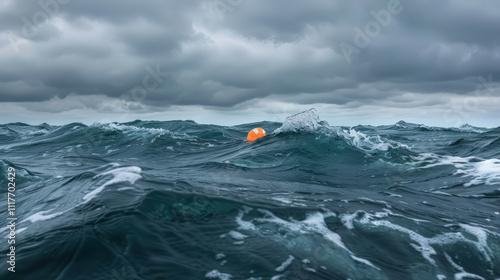 orange life buoy floating on rought sea photo