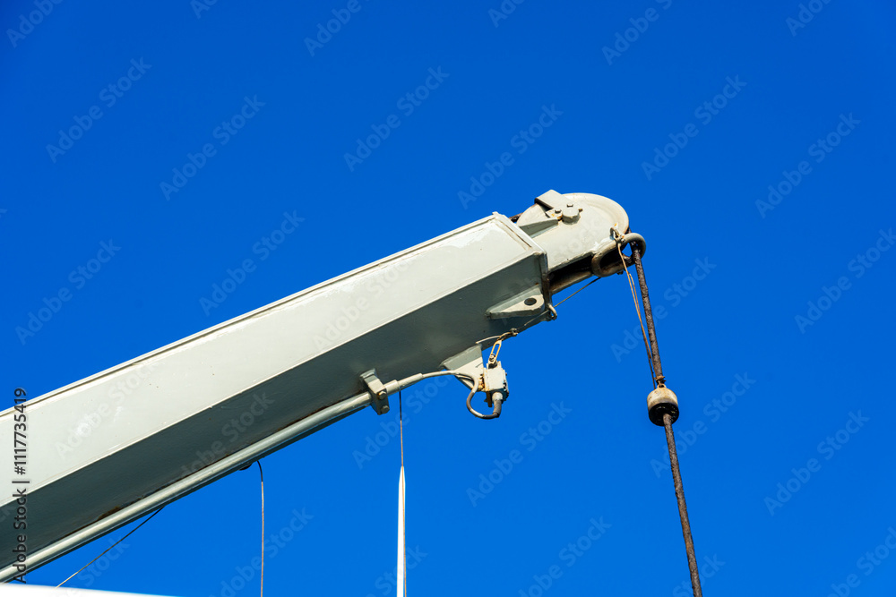 Industrial Crane Arm Against a Clear Blue Sky Industrial Crane Arm Against a Clear Blue Sky