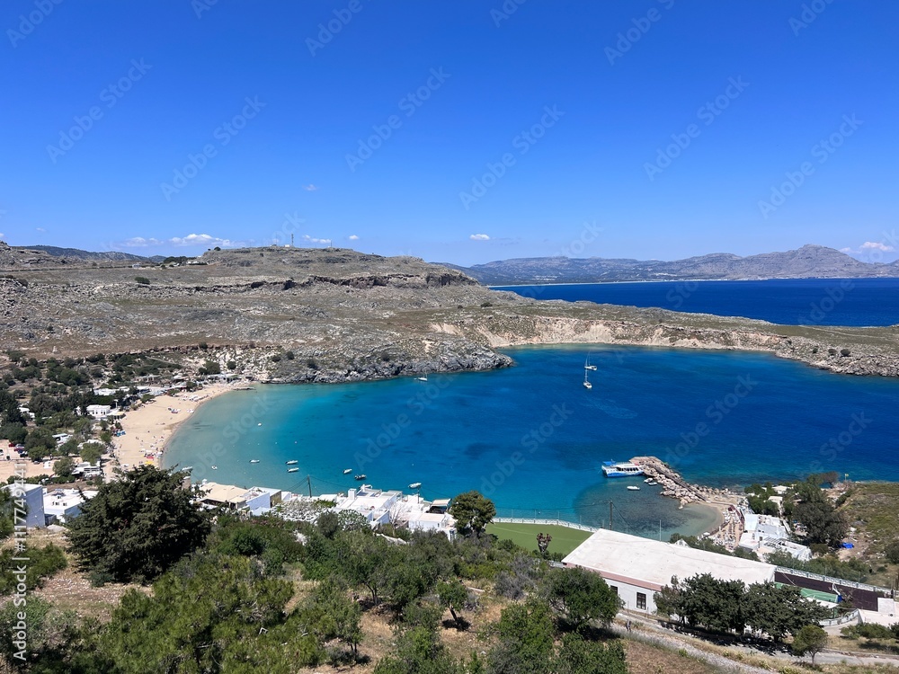 LINDOS, RHODES, GREECE - 2023. View from Lindos Acropolis to Lindos Beach LINDOS, RHODES, GREECE - 2023. View from Lindos Acropolis to Lindos Beach