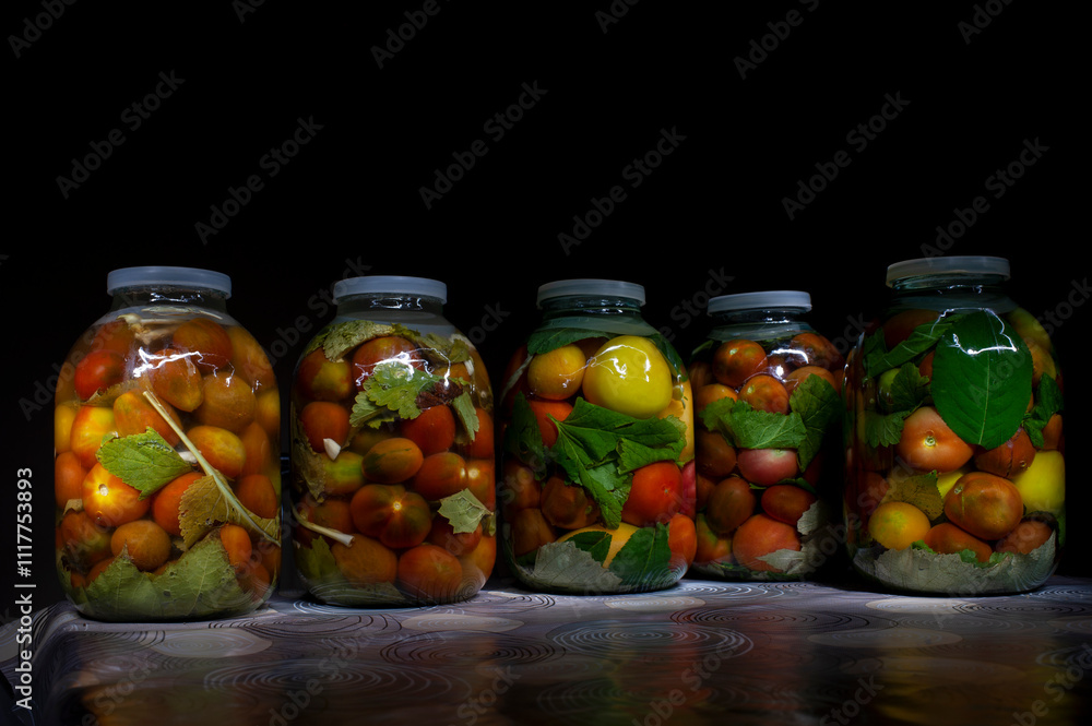 Salted tomatoes with mustard preserved in a glass jar. Healthy homemade fermented food. Home economics, preservation of the autumn harvest. Salted tomatoes with mustard preserved in a glass jar. Healthy homemade fermented food. Home economics, preservation of the autumn harvest.