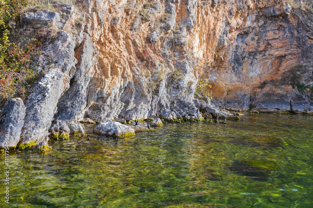 Breathtaking view of the rugged coastline of Lake Ohrid, showcasing the dramatic cliffs and crystal-clear waters. Breathtaking view of the rugged coastline of Lake Ohrid, showcasing the dramatic cliffs and crystal-clear waters.