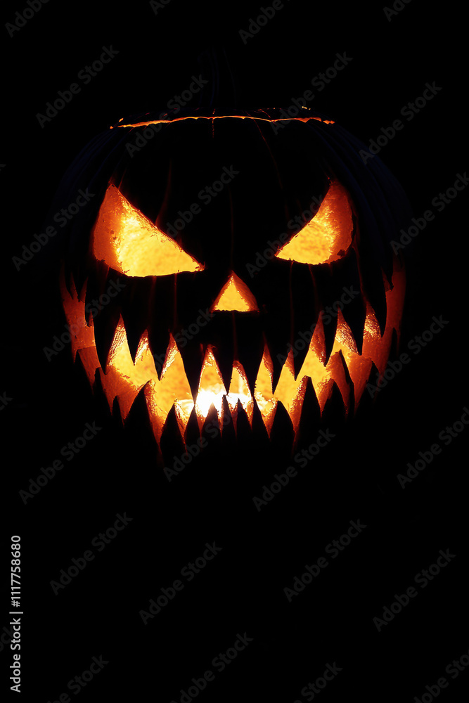 Fanged jack-o'-lantern isolated in the dark. Fanged jack-o'-lantern isolated in the dark.