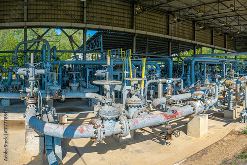 Petrochemical technology. Pipelines with valves in pump station in petrochemical technology. Industrial background. Industrial area