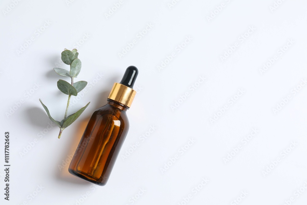 Eucalyptus essential oil in a glass bottle with green eucalyptus leaves on a wooden background. Aromatherapy concept. Spa. Natural organic ingredients for cosmetics and body care. Eucalyptus essential oil in a glass bottle with green eucalyptus leaves on a wooden background. Aromatherapy concept. Spa. Natural organic ingredients for cosmetics and body care.