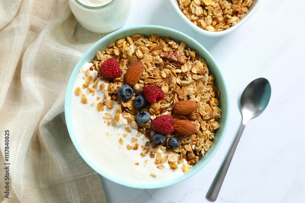 Delicious granola with berries and yogurt on a light background Delicious granola with berries and yogurt on a light background