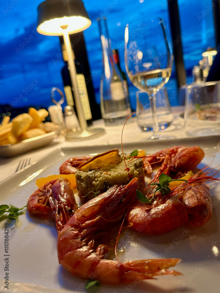 Elegant Seafood Dinner Setting With Wine and Ambient Lighting Elegant Seafood Dinner Setting With Wine and Ambient Lighting