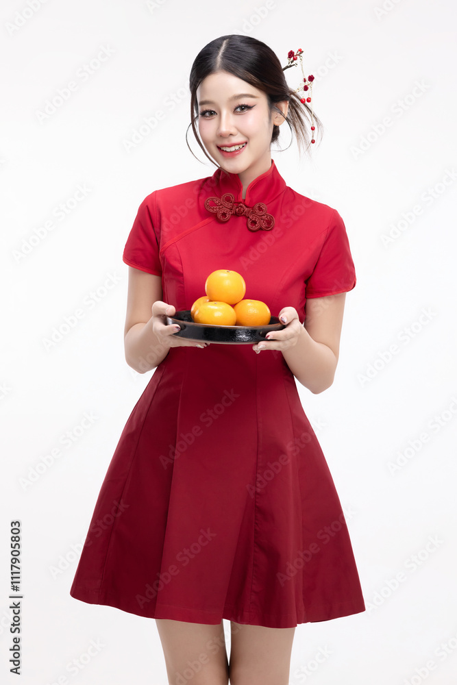 Portrait of joyful beauty Asian woman in red Cheongsam Chinese traditional dress celebrating with lucky fresh oranges on Chinese New Year festival isolated on white background. Portrait of joyful beauty Asian woman in red Cheongsam Chinese traditional dress celebrating with lucky fresh oranges on Chinese New Year festival isolated on white background.