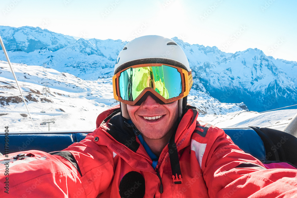 Happy skier taking selfie photo with smartphone camera sitting on ski lift - Young man having fun in winter snow resort - Sport, travel and vacation concept - Focus on face Happy skier taking selfie photo with smartphone camera sitting on ski lift - Young man having fun in winter snow resort - Sport, travel and vacation concept - Focus on face