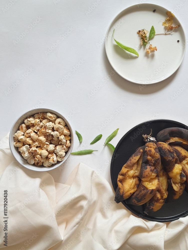 Popcorn and Banana on a white background Popcorn and Banana on a white background