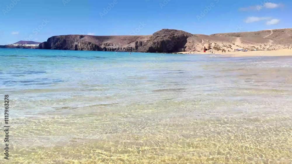 Playa de Mujeres. The sound of the wind and the ocean. Popular beach in Lanzarote on Playa Blanca. Canary Islands. Spain Playa de Mujeres. The sound of the wind and the ocean. Popular beach in Lanzarote on Playa Blanca. Canary Islands. Spain