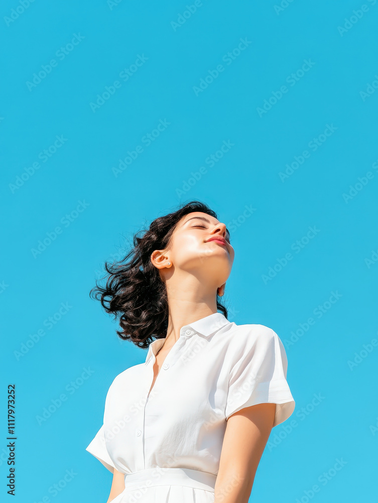 Minimalistic Portrait of a Woman Against a Clear Blue Sky Exuding Calmness and Confidence, Ideal for Lifestyle and Beauty Themes in Stock Photography Minimalistic Portrait of a Woman Against a Clear Blue Sky Exuding Calmness and Confidence, Ideal for Lifestyle and Beauty Themes in Stock Photography