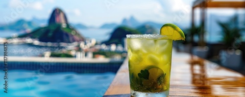 A cold caipirinha cocktail sits invitingly in the foreground with the famous Sugarloaf Mountain of Rio de Janeiro in the distance