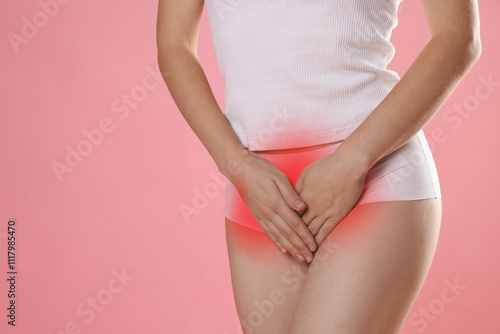 Wallpaper Mural STD (sexually transmitted diseases). Woman holding hands near her groin on pink background, closeup Torontodigital.ca