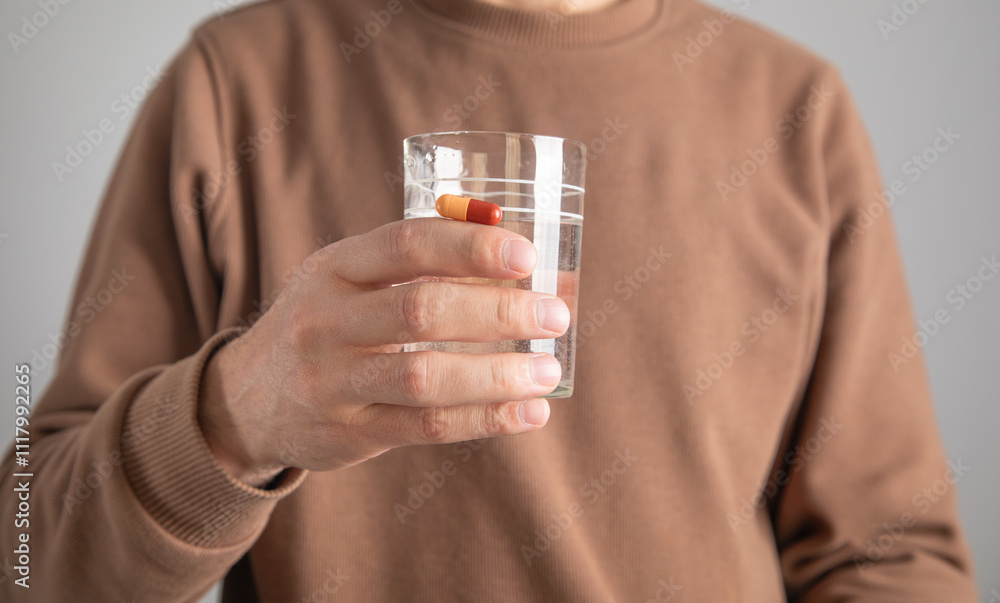 Caucasian man showing glass of water. Caucasian man showing glass of water.
