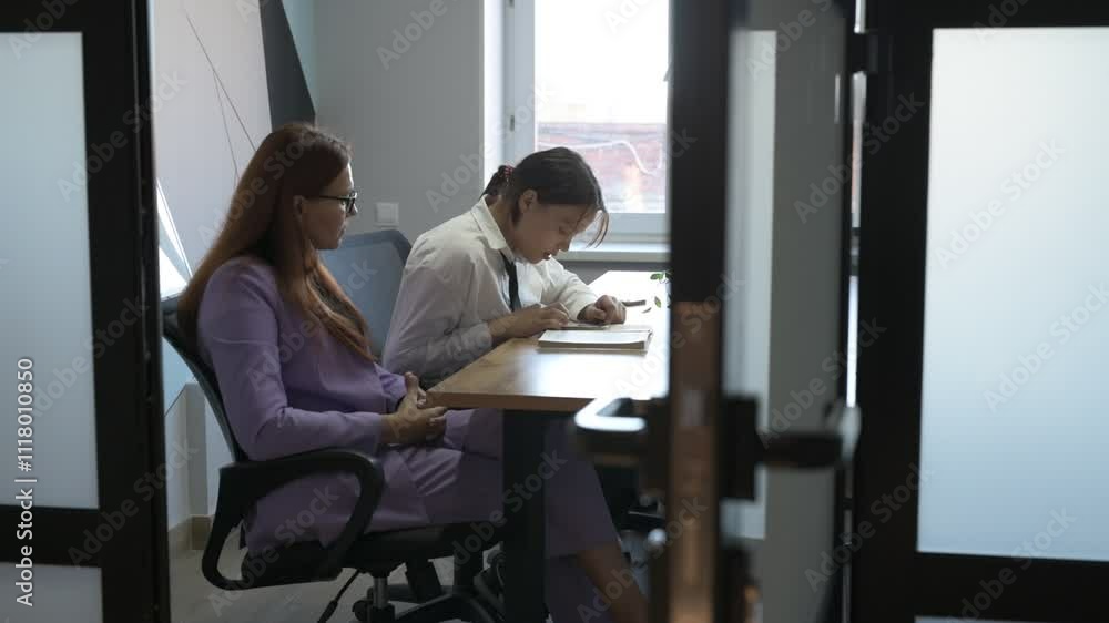 Schoolgirl and teacher have a lesson in the office, private lessons, distance learning Schoolgirl and teacher have a lesson in the office, private lessons, distance learning