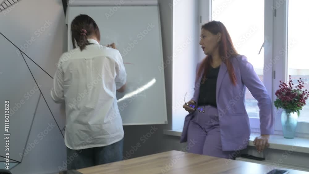Schoolgirl and teacher have a lesson in the office, private lessons, distance learning Schoolgirl and teacher have a lesson in the office, private lessons, distance learning