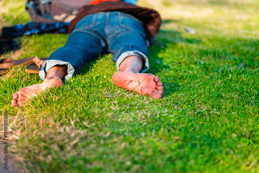 Relaxed Moment Outdoors: Person Resting on Vibrant Green Grass With Bare Feet and Rolled Jeans, Embracing Peaceful Nature Vibes and Casual Comfort in a Sunlit Park Setting Relaxed Moment Outdoors: Person Resting on Vibrant Green Grass With Bare Feet and Rolled Jeans, Embracing Peaceful Nature Vibes and Casual Comfort in a Sunlit Park Setting