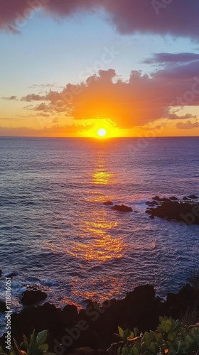 A vibrant sunset over the ocean, reflecting colors on the water.