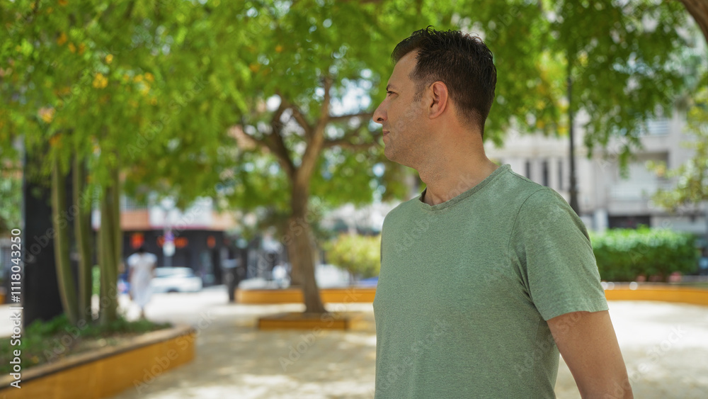 Middle age hispanic man standing outdoors in an urban park filled with lush greenery Middle age hispanic man standing outdoors in an urban park filled with lush greenery