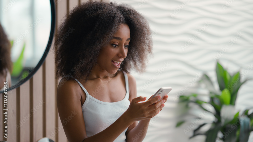 Excited African American woman girl female open mouth shock happy amazed achieve good news smartphone victory offer discount win influencer social media addict using mobile phone in bathroom success Excited African American woman girl female open mouth shock happy amazed achieve good news smartphone victory offer discount win influencer social media addict using mobile phone in bathroom success