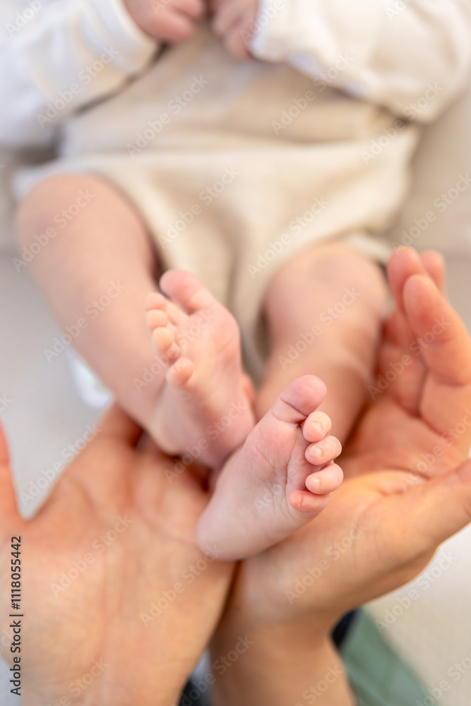 Parent holding in the hands feet of newborn baby. Mom holding baby feet. Parent holding in the hands feet of newborn baby. Mom holding baby feet.