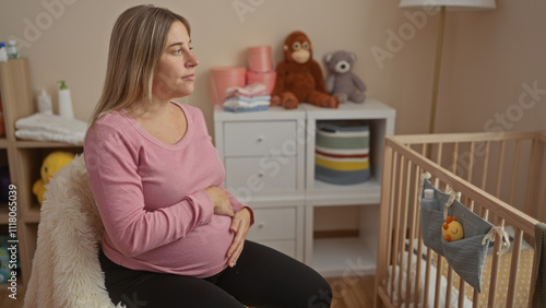 Pregnant woman sitting on bed in cozy bedroom with cradle nearby, anticipating baby while holding belly