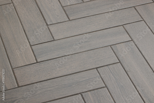 Фотография Experience stunning Herringbone Patterned Flooring in soft gray tones that enhan