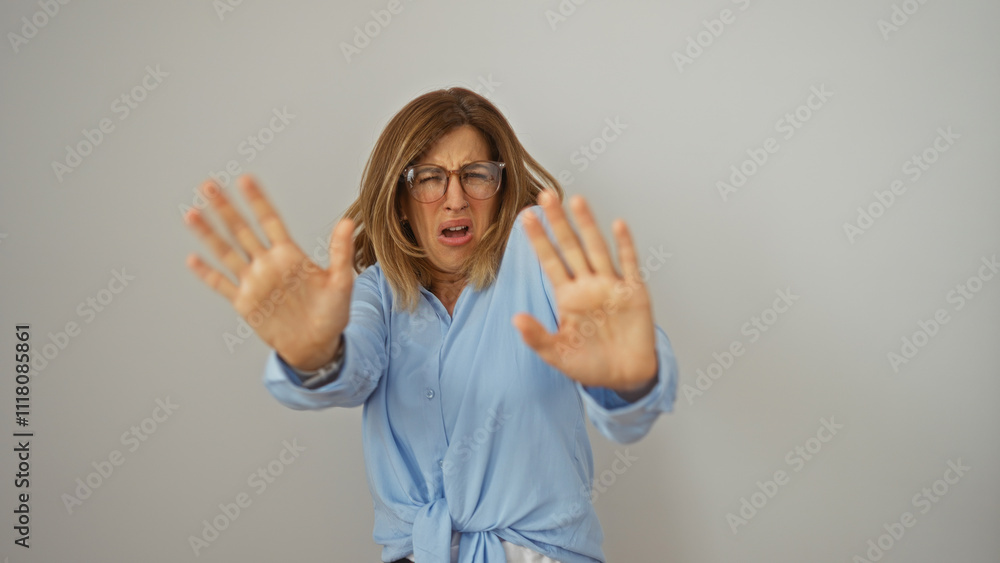 Φωτογραφία Young woman making stop gesture with hands in front of an isolated white background, expressing rejection or fear, blonde and wearing glasses