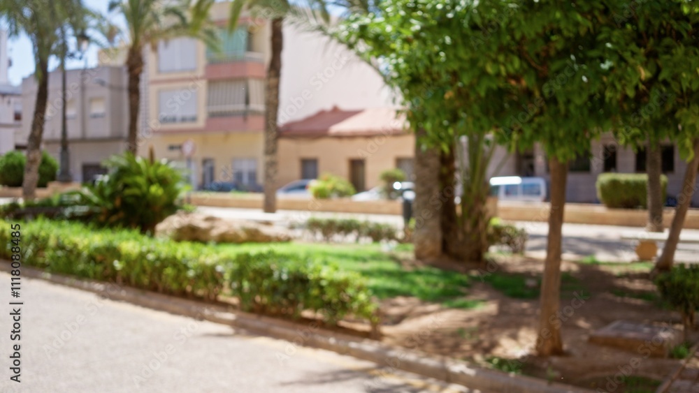 Blurry outdoor scene with defocused buildings, palm trees, and greenery creating a peaceful background. Blurry outdoor scene with defocused buildings, palm trees, and greenery creating a peaceful background.