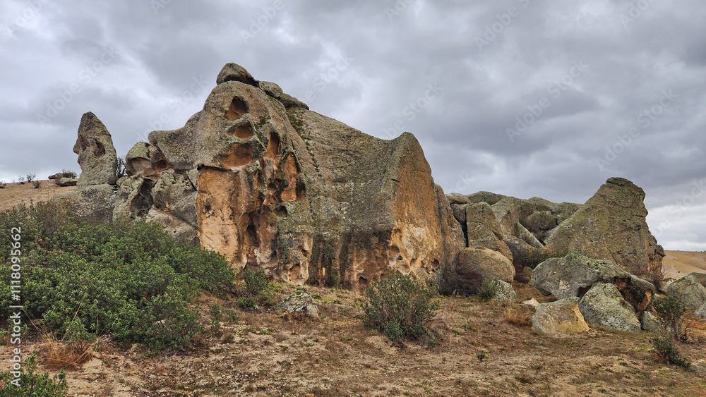 Beautiful rock formations in the west of famous Aslankaya Phyrgian Monument by the side of road to Doger town in Afyonkarahisar province in the evening of a severe rainy autumn day. Beautiful rock formations in the west of famous Aslankaya Phyrgian Monument by the side of road to Doger town in Afyonkarahisar province in the evening of a severe rainy autumn day.