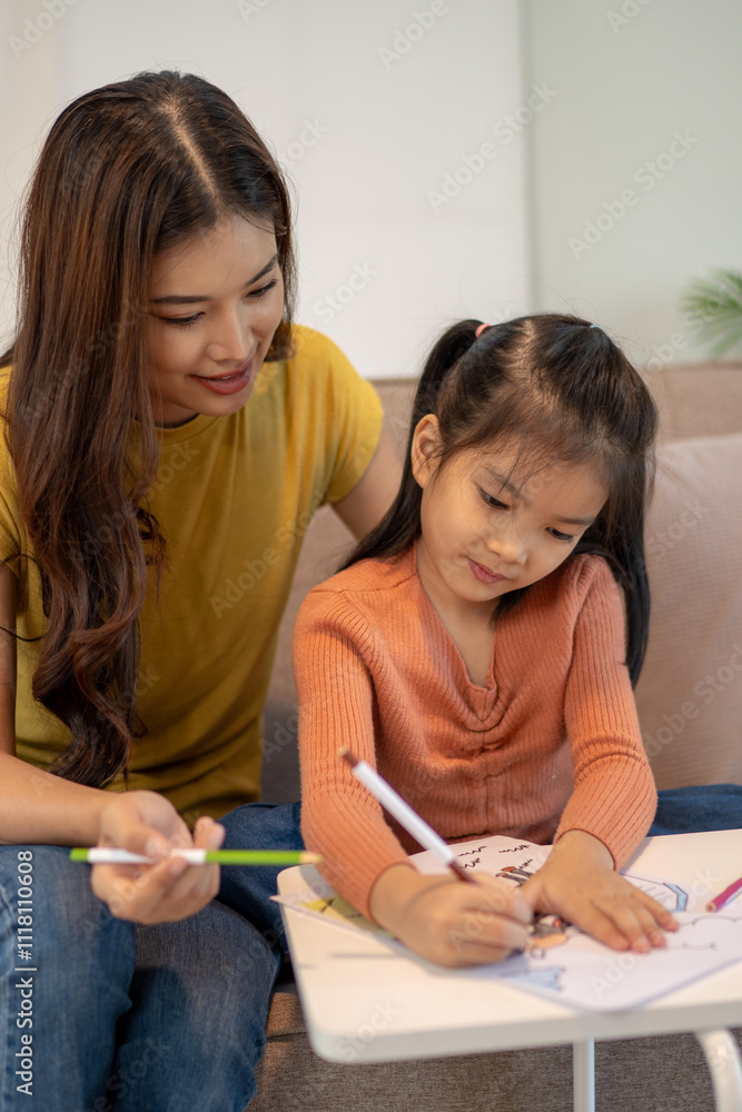 Lovely mom and little young daughter spending time together in their living room. Lovely mom and little young daughter spending time together in their living room.