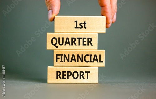 1st quarter financial report symbol. Concept words 1st quarter financial report on beautiful wooden blocks. Beautiful grey background. Business 1st quarter financial report concept. Copy space. photo